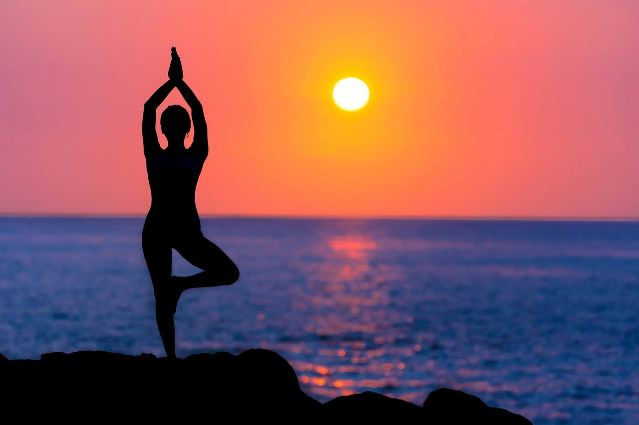 Yoga on a beach as sunset